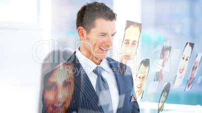Handsome businessman looking at profile pictures