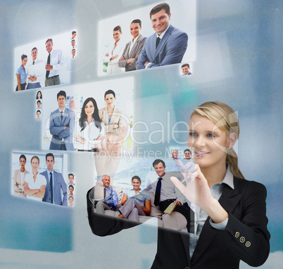 Blonde businesswoman selecting image from digital interface