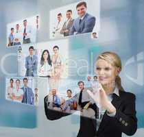 Blonde businesswoman selecting image from digital interface