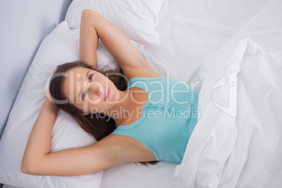 Charming woman relaxing lying on a bed