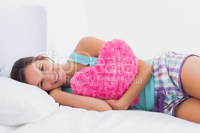 Happy woman lying in bed