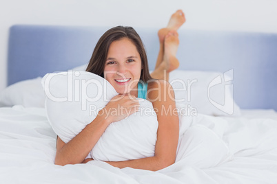 Smiling woman lying in bed