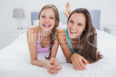 Friends lying in bed