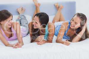 Girls lying on bed and talking