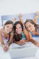Girls on bed with laptop