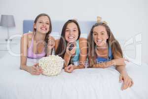 Friends eating popcorn and laughing