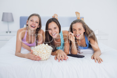 Friends eating popcorn and watching tv