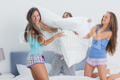 Friends having pillow fight