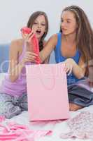 Girls sitting in bed after shopping