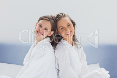 Smilling friends wearing bathrobe