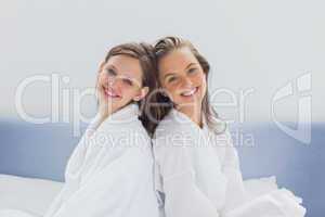 Smilling friends wearing bathrobe