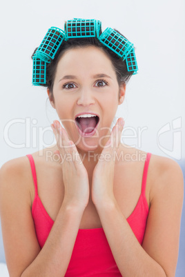 Girl wearing hair rollers looking at camera