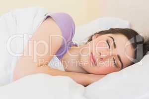 Smiling girl sleeping in her bed