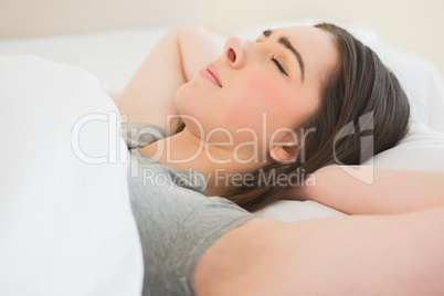 Brunette sleeping in her bed