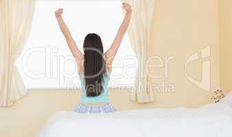Girl stretching sitting on her bed