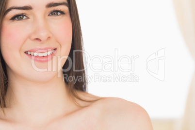 Smiling nude girl looking at camera
