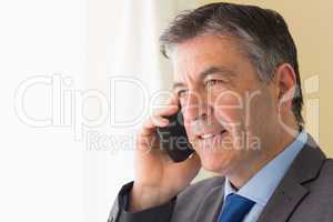 Concentrated man calling someone with his mobile phone