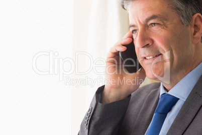 Thoughtful man calling someone with his mobile phone