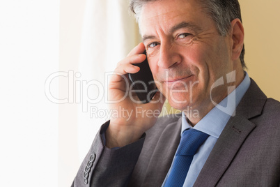 Content man calling someone with his mobile phone