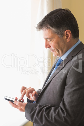 Focused man texting on his mobile phone