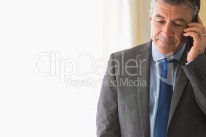 Concentrated man calling someone with his mobile phone