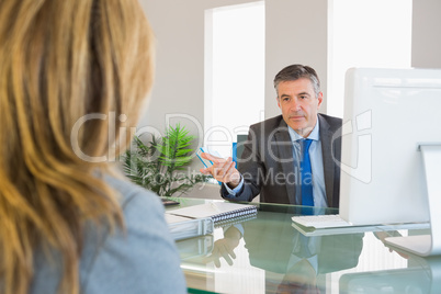 Serious businessman having a discussion with a colleague
