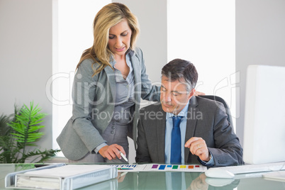 Attentive businesswoman explaining figures to a businessman