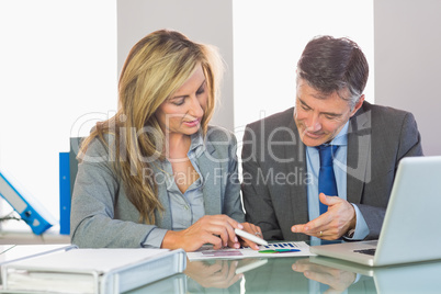 Two content business people trying to understand figures