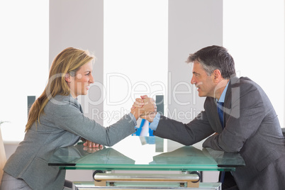 Two businesspeople having a showdown sitting around a table