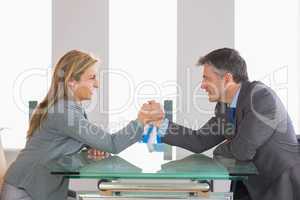 Two businesspeople having a showdown sitting around a table