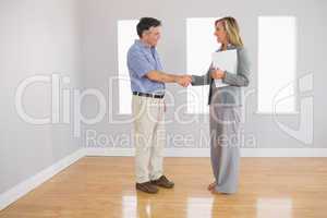 Serious realtor shaking the hand of her buyer