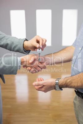 Close up of a handshake and a key delivery