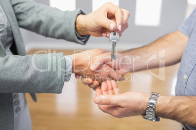 Close up of a handshake and a key delivery
