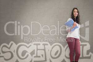 Cheerful student holding notebook posing