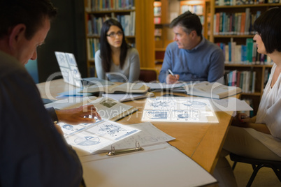 Focused mature students working on their digital tools