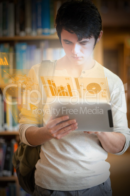 Serious handsome student working on his futuristic tablet