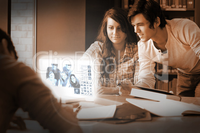 Smiling students watching photos on their digital interface