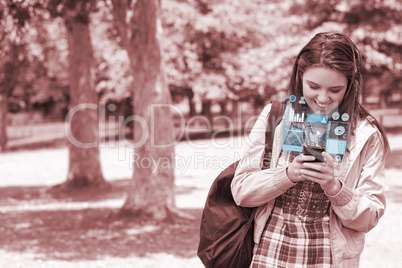 Cheerful young woman texting on her futuristic smartphone