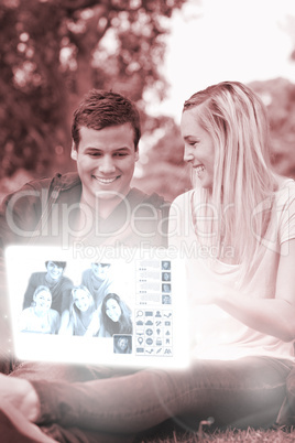 Cheerful young couple watching photos on digital interface