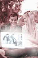 Cheerful young couple watching photos on digital interface