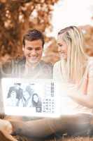 Happy young couple watching photos on digital interface