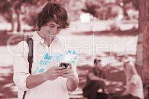 Happy student using his digital smartphone