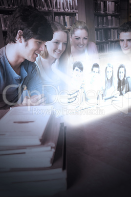 Cheerful college friends watching photos on futuristic interface