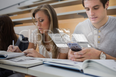 Serious college student working on futuristic smartphone