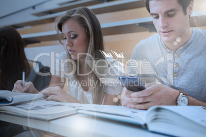 Concentrated college student working on futuristic smartphone