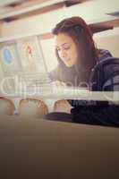 Focused college student working on her digital laptop