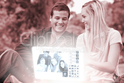Cheerful young couple watching photos together on digital interf