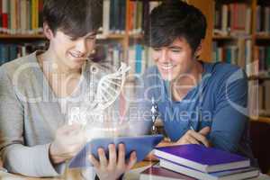 Students using futuristic hologram to learn biology from tablet