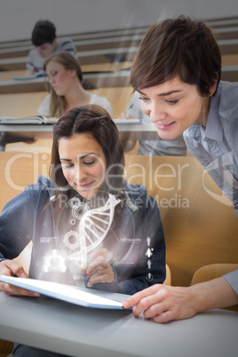 Student and teacher using futuristic hologram to learn biology f
