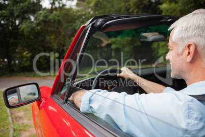 Handsome mature man driving cabriolet